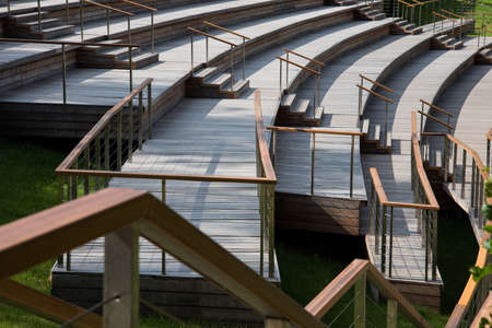 Beautiful curved benches for spectators under the open sky. Landscape design.