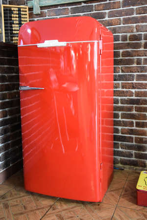 Old red vintage fridge, in a natural setting. Current Antiques. Cafe.の写真素材