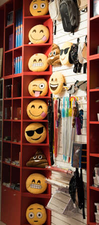 a lot of different toys-smiles, toys with different moods, exhibited in the shop window.