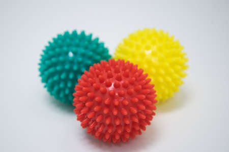Massage balls. Three different colored balls on a white background. Close up.