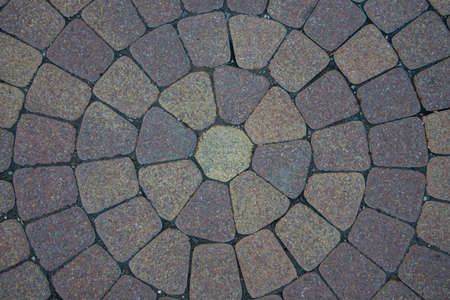 Sidewalk tiles laid out from the center. The circular walls. Flower, the shape of the sun.