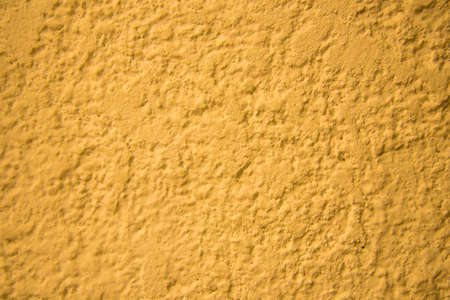 Yellow wall texture. Bright warm yellow wall backgroundの写真素材