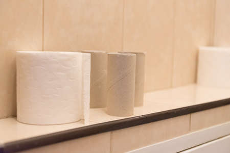 paper roll of toilet paper. next to it are empty bushings from the finished roll. Concept of diarrheaの写真素材