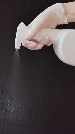 Spraying an antibacterial disinfectant spray. Dispenser of disinfectant for surfaces. Concept of infection control. for the prevention of colds, viruses, coronaviruses, and flu. Spray. Alcohol spray. Epidemic.の写真素材