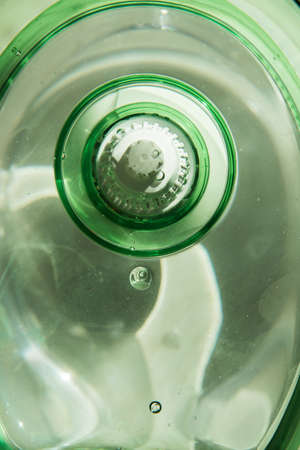 Close-up of a jug with a water purification cartridge. The cartridge shows air bubbles under the water. The concept of purification.の写真素材