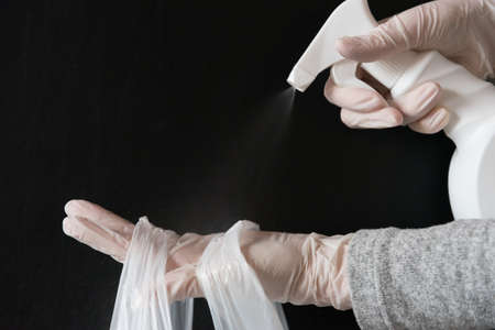 Hands of a person disinfecting a delivery bag. Safe delivery.の写真素材