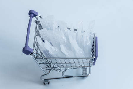 There are medical supplies in the shopping basket. The vaccine for coronavirus. The concept of the purchase.の写真素材