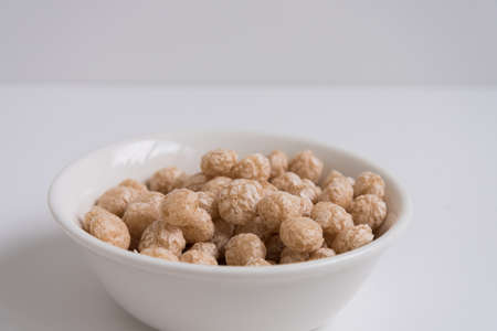 Balls for Breakfast, top view. A white plate filled to the top with Breakfast balls. light colors.