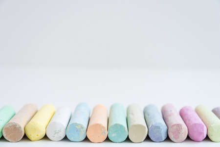Round colored crayons are arranged in a row. Front view. White. Spectrum.の写真素材