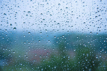 raindrops on the glass close-up. Background texture. Bad weather. Blue shades.の写真素材