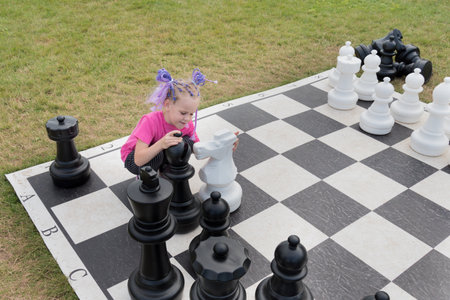 a beautiful girl embraces a large pine tree. figure. The concept of love for chess and strategy.の写真素材