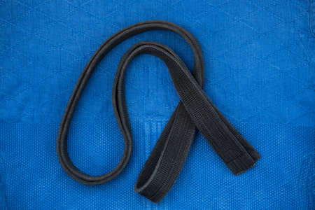 The view from the top. Kimono for judo classes and a black belt. The kimono is blue. Background,...
