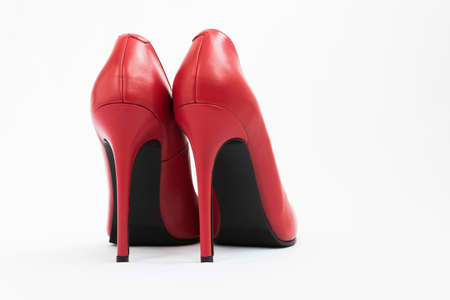 High-heeled shoes in red. Sexy shoes. White background. There is space for textの写真素材
