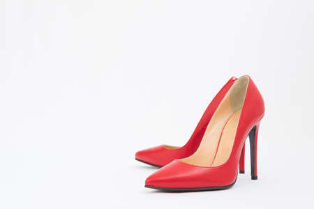 High-heeled shoes in red. Sexy shoes. White background. There is space for textの写真素材