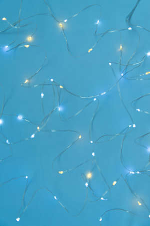 Texture of New Year or Christmas garland on a blue background. Abstract painting