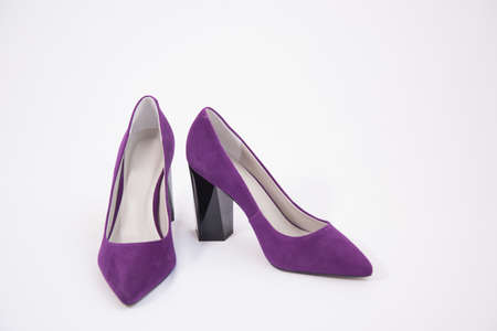 A pair of purple high-heeled shoes. Suede womens elegant shoes on a white backgroundの写真素材