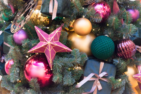 The Christmas tree is decorated with beautiful decorations. The color of Christmas decorations is...