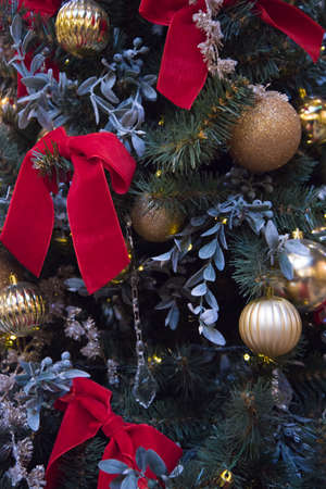 Stylish Christmas tree with large red bows. Bows made of fabric are the main decoration of the Christmas tree.の写真素材