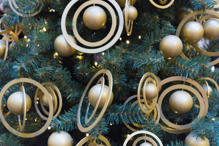 The Christmas tree is decorated with stylish golden balls. Trend direction in monochrome design....