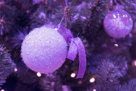 The Christmas tree is decorated with a delicate sparkling Christmas ball. Stylish design for Christmas and New Year. Trendy color of Christmas tree and decorations for the holiday.の写真素材