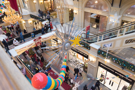 Moscow, Russia - December 2021: GUM store is decorated internally for Christmas and New Year. Stylish decoration with retro toys and balloons. Festive mood.View from the top floor.のeditorial素材