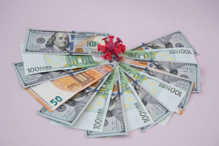 On the euro bills is a cage with coronavirus. The concept of pandemic costs. Costs of health and social assistance.の写真素材