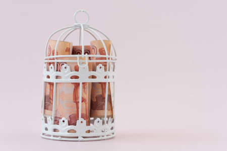 Money is locked in a metal cage. Russian rubles with a face value of 5000. Bills under lock and key. The concept of accumulating money. No investment, no development, money doesnt work.の写真素材