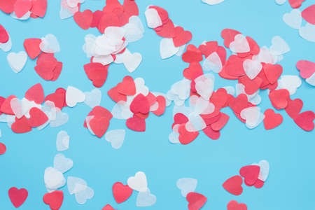 Red and white hearts on a blue background. Background, texture for valentines day card, wedding day or engagement.の写真素材