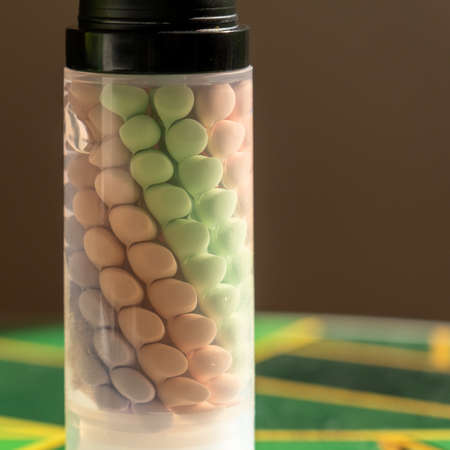 A jar with drops of colored makeup base. Drops are stored in a special gel. Color correction of skin...