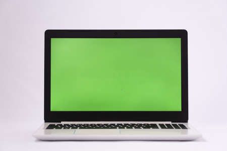Laptop with green chroma key screen. Laptop on a white background