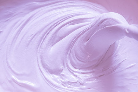 Mixing building mix. Putty for walls. Beautiful slow motion, the texture of the putty is clearly visible. Delicate pink colorの写真素材