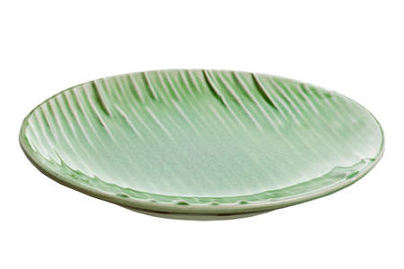 Empty plate with wavy pattern, Green plate with wave texture isolated on white background, Side viewの写真素材