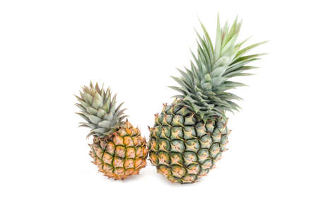 Ripe pineapple on a white twinsの写真素材