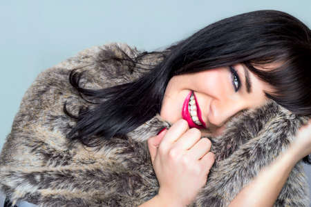 Pretty girl with a fur coatの写真素材