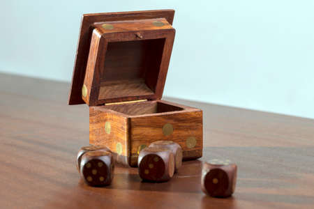 Wooden dices for a jamb game on a wooden tableの写真素材