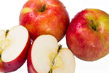 Red apple slices wet isolated on white backgroundの写真素材