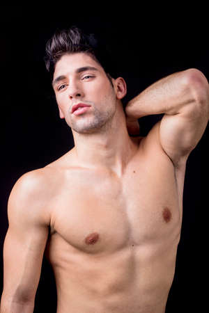 Sexy man posing on a black backgroundの写真素材