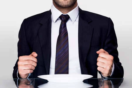 Businessman dining with a empty plateの写真素材