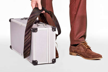 Man leaving with a suitcase and tieの写真素材