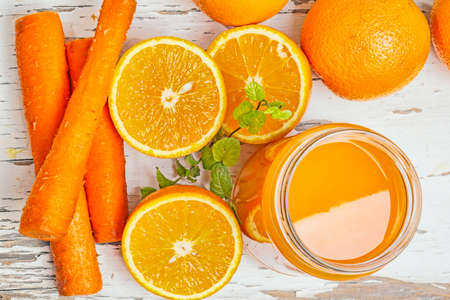 Orange and carrot juice with menthol leafの写真素材