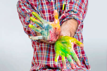 Finger paint on an adult handsの写真素材