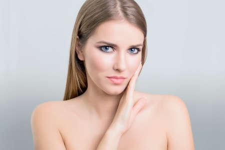 Beauty portrait of a woman touching her faceの写真素材