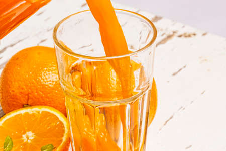 Orange juice pouringの写真素材