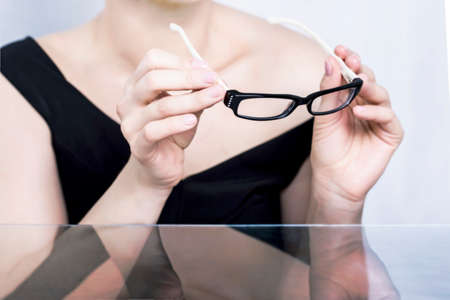 Business woman holding glassesの写真素材