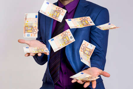 Businessman trowing moneyの写真素材