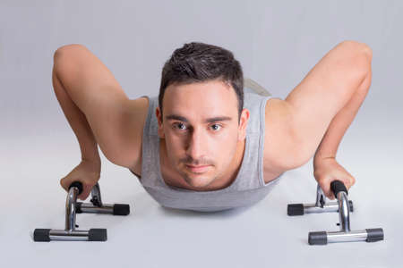 Man doing push ups in studioの写真素材