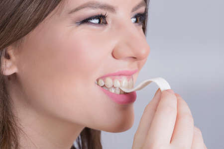 Girl smiling and chewing a gumの写真素材