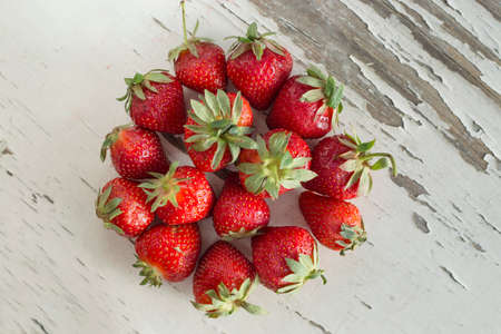 Strawberries on a white vintage tableの写真素材