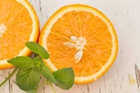 Orange slices and mint in daylightの写真素材