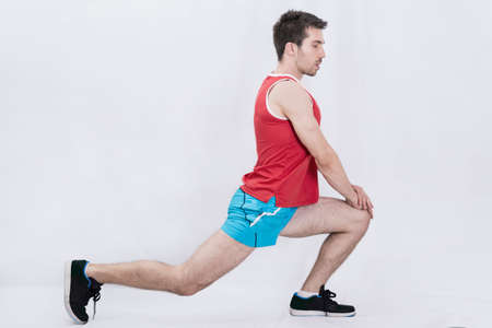Sportsman stretching in studioの写真素材